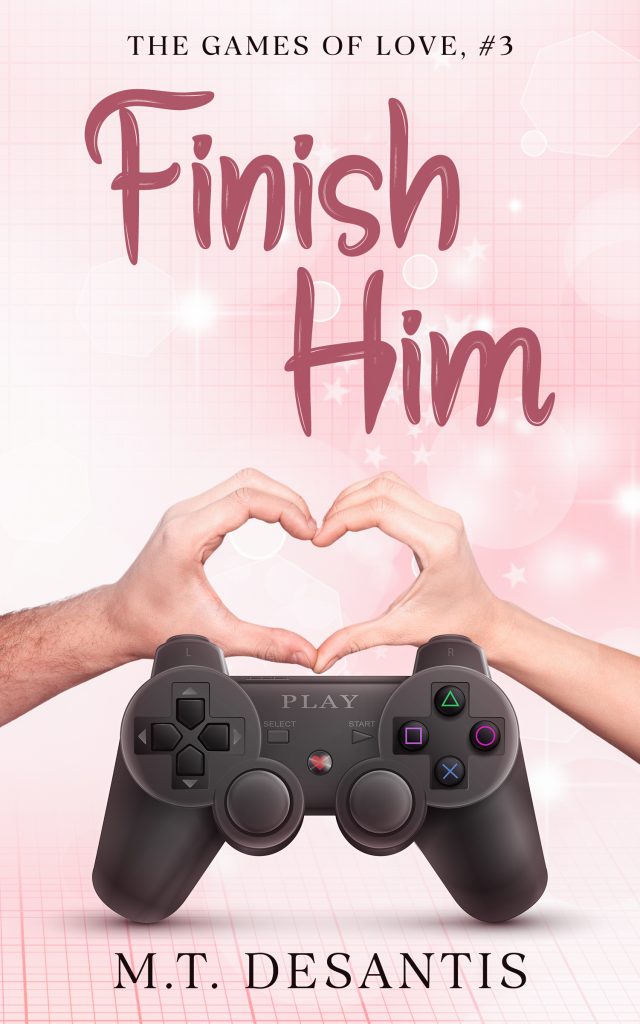 Two hands form a heart shape over a grid background. A video game controller is in front of the hands. The title 'Finish Him, The Games of Love, #3' is at the top, and author name 'M.T. DeSantis' is below the hands image.