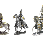 A knight in silver armor riding a white horse with matching armor, against a blurry green background.