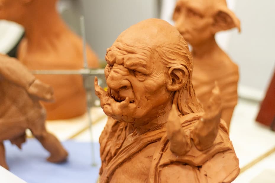 Two grumpy clay troll figurines sitting together having some troll talk.